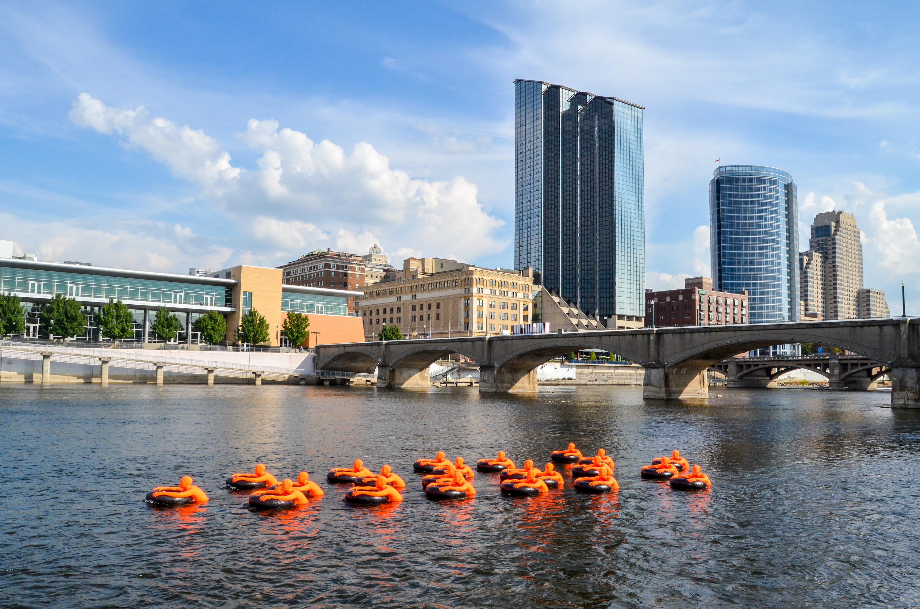 "SOS (Safety Orange Swimmers)" by A+J Art + Design, in the Grand River near Ah-Nab-Awen Park